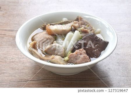 large rice noodles chop and crispy pork topping blood in clear soup on bowl    127319647