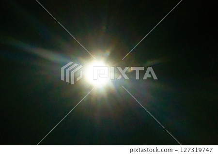 Sun flare on the black background Sun flare on the black background 127319747