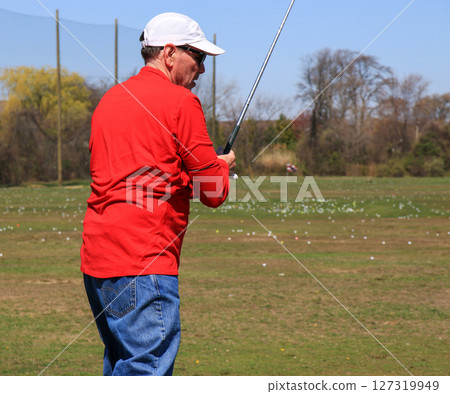 Golf Swing at the Driving Range on a Sunny Afternoon Golf Swing at the Driving Range on a Sunny Afternoon 127319949