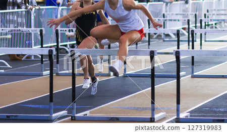 Young Athlete Competes in Hurdle Race at Outdoor Track Event Young Athlete Competes in Hurdle Race at Outdoor Track Event 127319983