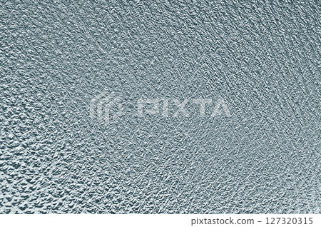 Textured plaster wall creating intriguing light and shadow play Textured plaster wall creating intriguing light and shadow play 127320315