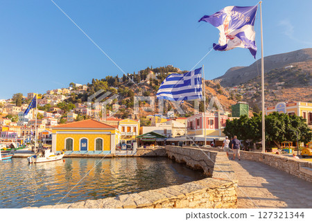 Greek flags on waterfront in Symi, Greece 127321344