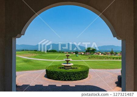 Fountain by golf courses of hill valley against blue sky in Khao Yai 127321487