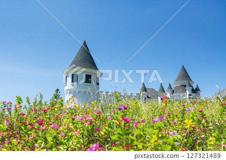 White hotel castle againt spring flower and blue sky White hotel castle againt spring flower and blue sky 127321489