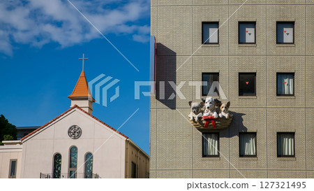 Dog hospital and hotel by church against blue sky, Osaka, Japan 127321495