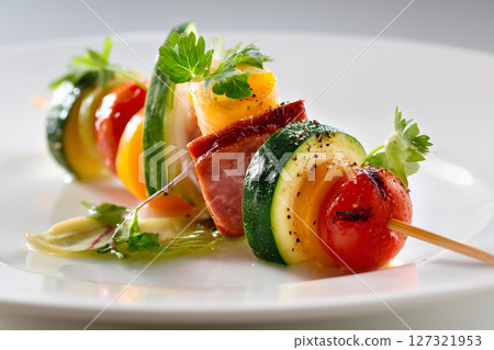 Skewers on a rectangular plate with garnish. Skewers on a rectangular plate with garnish. 127321953