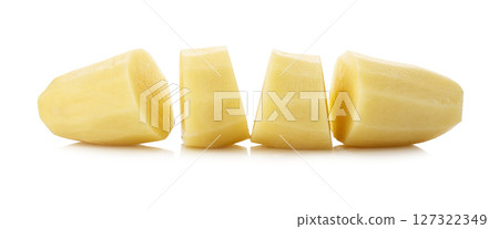 Raw potatoes cut into pieces isolated on a white background Raw potatoes cut into pieces isolated on a white background 127322349