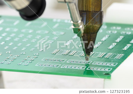 The automatic soldering machine operation with PCB board. The automatic soldering machine operation with PCB board. 127323195