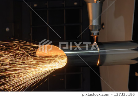 Close up scene the fiber laser cutting machine cut the stainless steel tube with sparkling light. 127323196