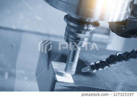 The CNC milling machine rough cutting the mold parts by indexable tools in the light blue scene. The CNC milling machine rough cutting the mold parts by indexable tools in the light blue scene. 127323197