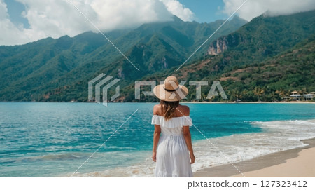 a young woman in white dress looking at the sea a young woman in white dress looking at the sea 127323412