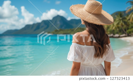 a young woman in white dress looking at the sea 127323413
