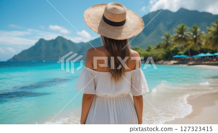 a young woman in white dress looking at the sea 127323415