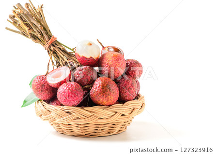Juicy Lychee with cut in half and leaves on bamboo basket isolated on white background. Thai fruits 127323916