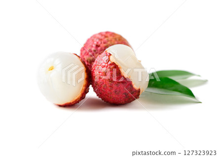 Three Juicy Lychee with cut in half and leaves isolated on white background. Three Juicy Lychee with cut in half and leaves isolated on white background. 127323923