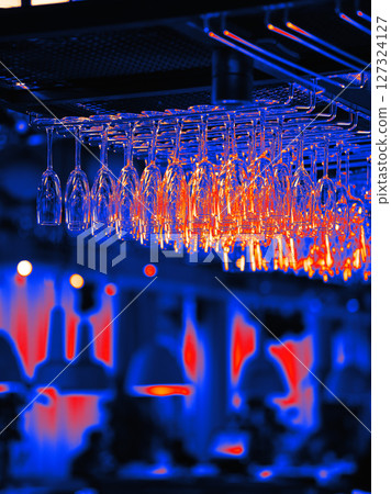 Infrared Thermal image of row of clean empty glasses in bar. Moody aesthetic Thermal image of bar and restaurant atmosphere with many upside down empty wine glasses 127324127