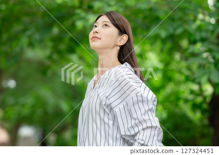 A woman relaxing in the fresh greenery 127324451