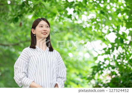 A woman relaxing in the fresh greenery 127324452