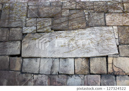 Osaka Castle's stone wall lined with square stones 127324522