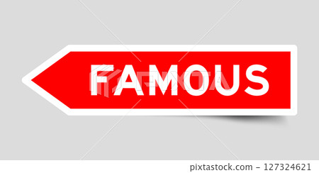Red color arrow shape sticker label with word famous on gray background 127324621