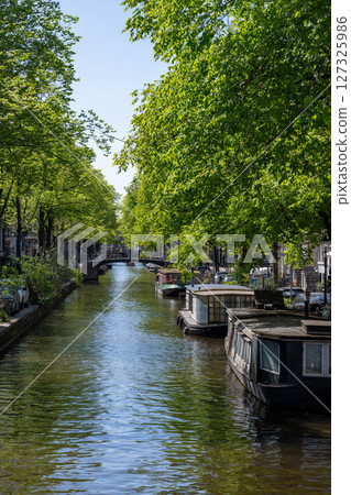 Scenery along the canal in Amsterdam/Netherlands Scenery along the canal in Amsterdam/Netherlands 127325986