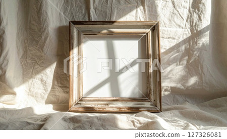 Empty White Frame on Beige Fabric with Sunlight Shadows 127326081