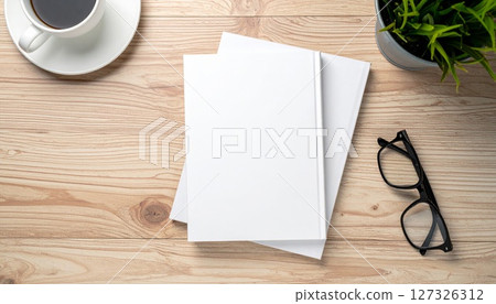 White Book Mockup on Wooden Desk with Coffee and Plant 127326312