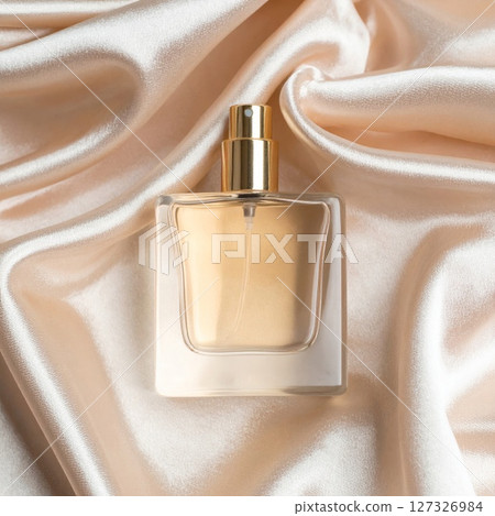 Gold Perfume Bottle on Beige Satin Fabric 127326984