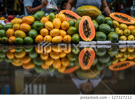 Colorful Fruit Stall Reflections in Tropical Outdoor Market After Rainfall 127327212