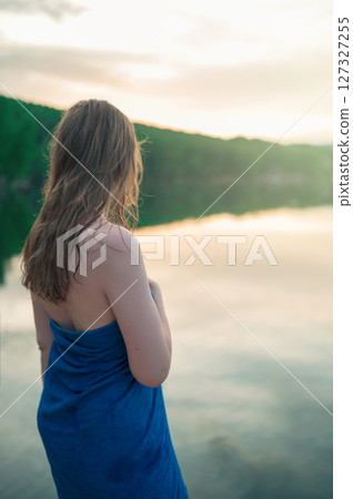 Young Woman in Towel by a Tranquil Lake 127327255