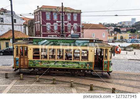 Driving in a Porto heritage tram along the Douro river 127327345