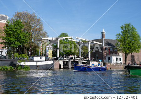 Amsterdam cityscape from a cruise ship, drawbridge, Netherlands Amsterdam cityscape from a cruise ship, drawbridge, Netherlands 127327401