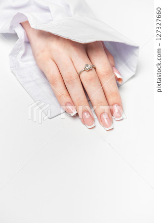 Woman hand showing french manicure and elegant ring on white background 127327660