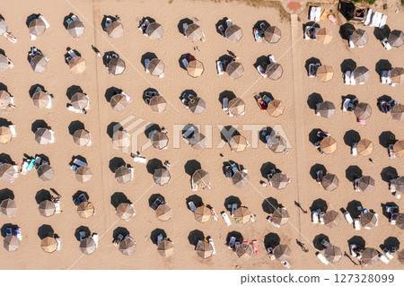 Aerial view to a sandy beach and sunshade with sunumbrellas Aerial view to a sandy beach and sunshade with sunumbrellas 127328099