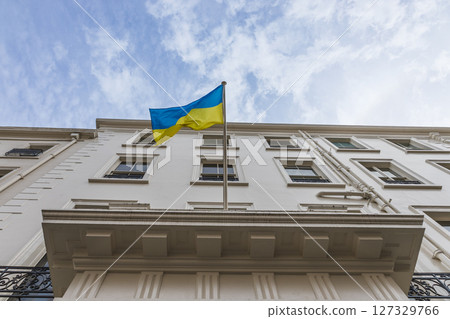Ukrainian National Flag Flying Above Historic City Building Facade 127329766