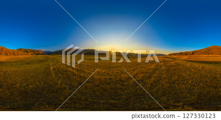 Spherical HDRi panorama of straw field surrounded with foothills at autumn sunset 127330123