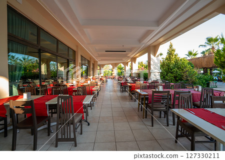 Outdoor terrace of an empty cafe and restaurant. Outdoor terrace of an empty cafe and restaurant. 127330211