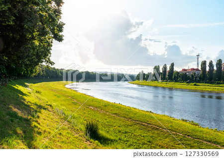embankment of the river uzh in morning light. picturesque european riverside. wonderful urban landscape in summer. linden alley on the left shore 127330569