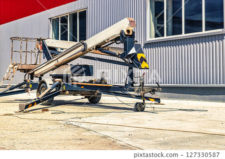 Construction telescopic tower or work platform for people to work at height. Powerful work platform for lifting construction workers up. Construction telescopic tower or work platform for people to work at height. Powerful work platform for lifting construction workers up. 127330587