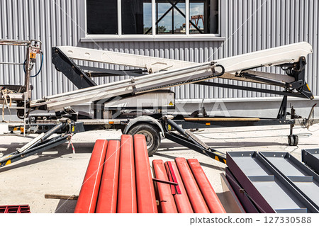 Construction telescopic tower or work platform for people to work at height. Powerful work platform for lifting construction workers up. Construction telescopic tower or work platform for people to work at height. Powerful work platform for lifting construction workers up. 127330588