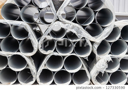 Pipe elements for the installation of roof drainage and rainwater drainage at the construction site. Materials are stored for the installation of a storm water drainage system. 127330590