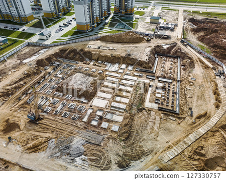 Monolithic reinforced concrete foundations or grillages for the construction of a large modern residential building. Rostverk at the construction site. Foundation for the building. View from above. 127330757