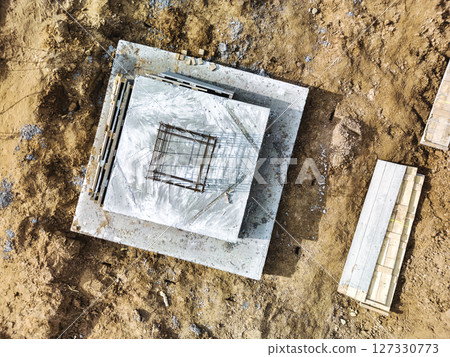 Monolithic reinforced concrete foundations or grillages for the construction of a large modern residential building. Rostverk at the construction site. Foundation for the building. View from above. 127330773