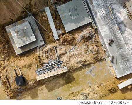 Monolithic reinforced concrete foundations or grillages for the construction of a large modern residential building. Rostverk at the construction site. Foundation for the building. View from above. 127330774
