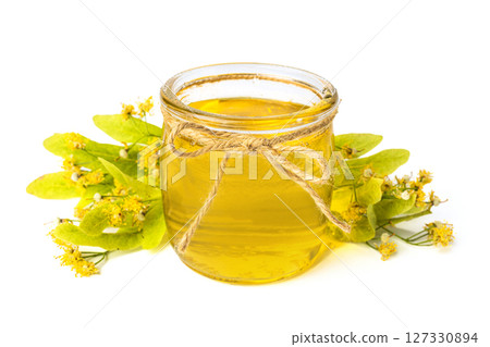 Isolated Honey bee in glass jar and with honey dipper on white background 127330894