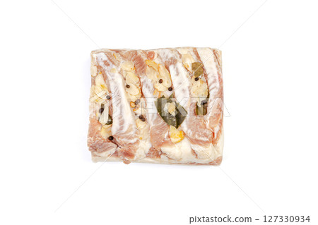 Lard or salo with bay leaf and black peas isolated on white background. 127330934