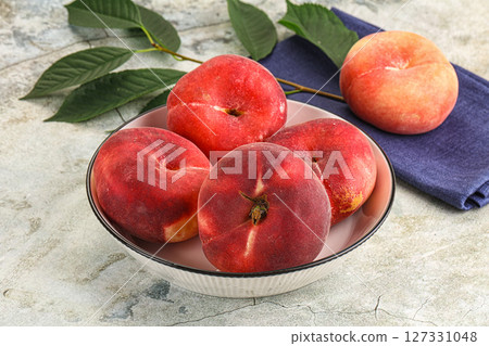 Ripe sweet and juicy Flat peach 127331048