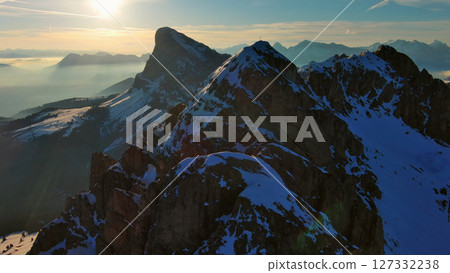 Rocky snow mountains at sunrise aerial 127332238