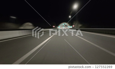 Driving on modern highway at night 127332269