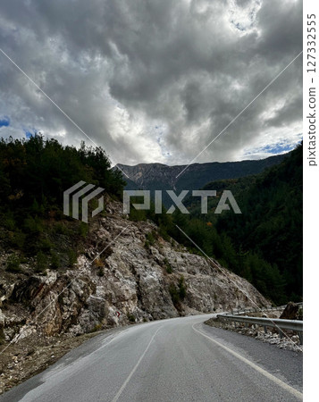 Mountainous road sky. Cloudy road landscape. High quality photo 127332555